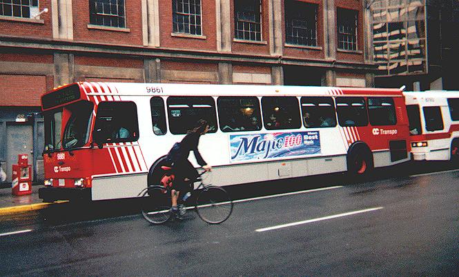 6Wrecks's tweet photo. 9861 is seen here on Slater Street in June 2001.  The livery on this bus was only used on buses purchased during 1997 and 1998; in 1999, the “maple leaf” livery was introduced.

#OGTranspo https://t.co/qGrrsE0rgD