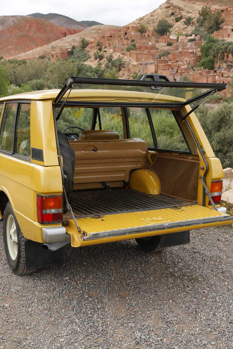 Yellow Range Rover Classic 1970s with split tailgate open
