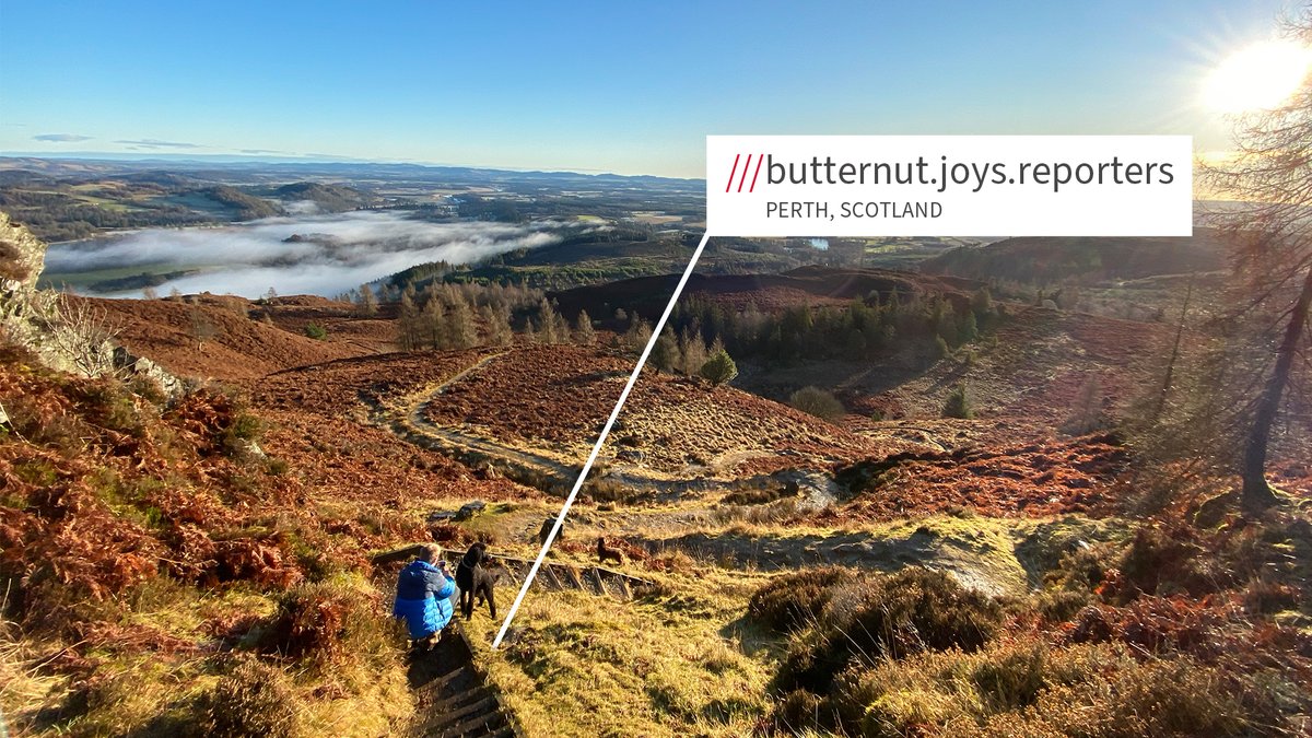 Two hikers are resting on a hill at ///butternut.joyd.reporters in Perth, Scotland. It's a very remote location, no other people are around, the view stretches off into the distance.