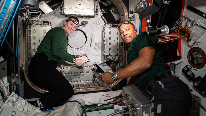 NASA astronauts Kate Rubins and Victor Glover work on the new NanoRacks Bishop airlock.