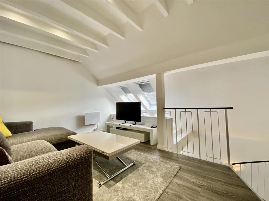 1 bed flat in the merchant city that doesn& #39;t have any windows you can look out of minus the 2 roof lights behind the tv... somehow worth £150k