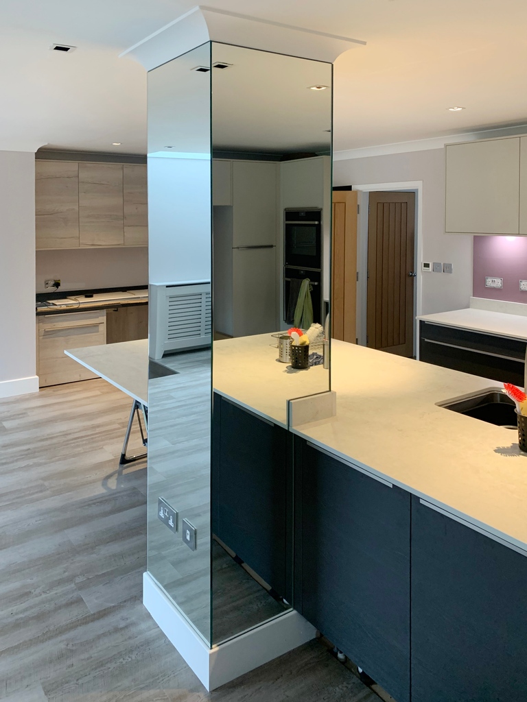 Making a feature today by installing our silver mirror around this beautiful pillar 😍 Expertly measured and installed by our team it creates a great look in this kitchen and adds light around the room. #mirrorcladding #architecturaldesign #mirror #interiordesign #interiorideas