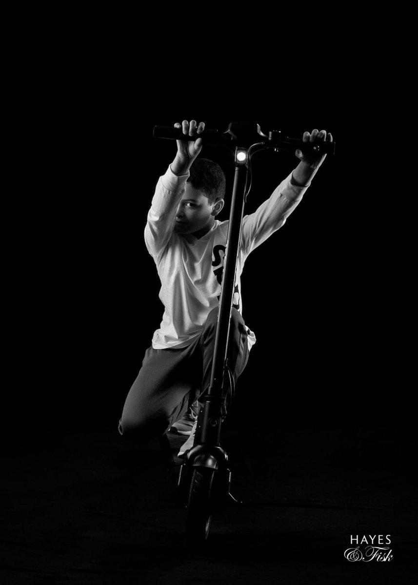Well this kiddo absolutely loves his scooter and all things fast!  Love this black and white artist portrait of him doing exactly what he loves to do.
