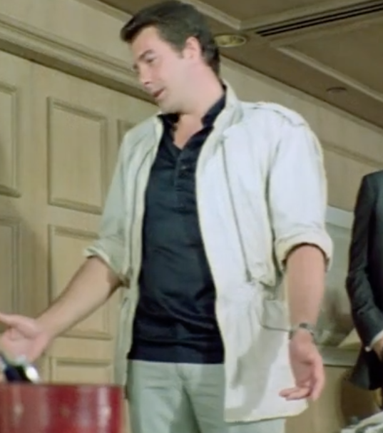 FightingOnFilm's tweet photo. Also some cracking 80s fashion on display. Collins weird cream safari jacket with navy satin polo, and. the American baddies Lacoste polo! #Drip #Codenamewildgeese https://t.co/TAOwc7EggR