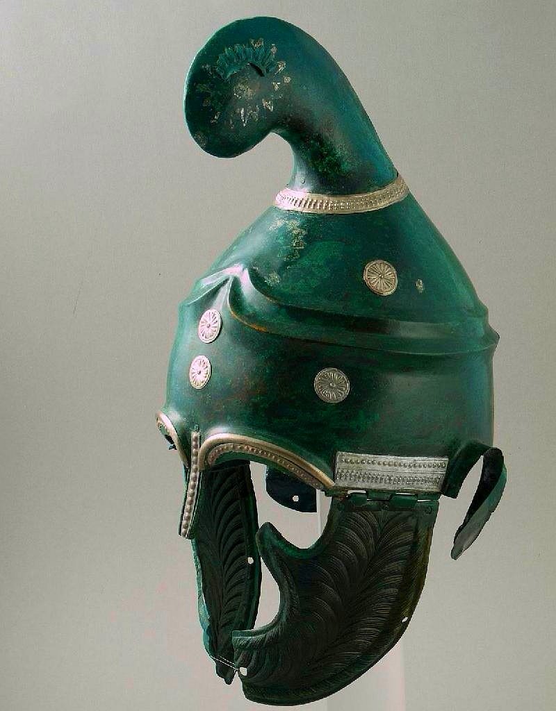 A 4thC BC bronze Thracian helmet discovered by chance in 1997 at the village of Pletena, Bulgaria. Decorated with silver bands and eyebrows with bearded patterns on the cheekpieces and a large Phrygian style crest. Now in the national history museum, Sofia.