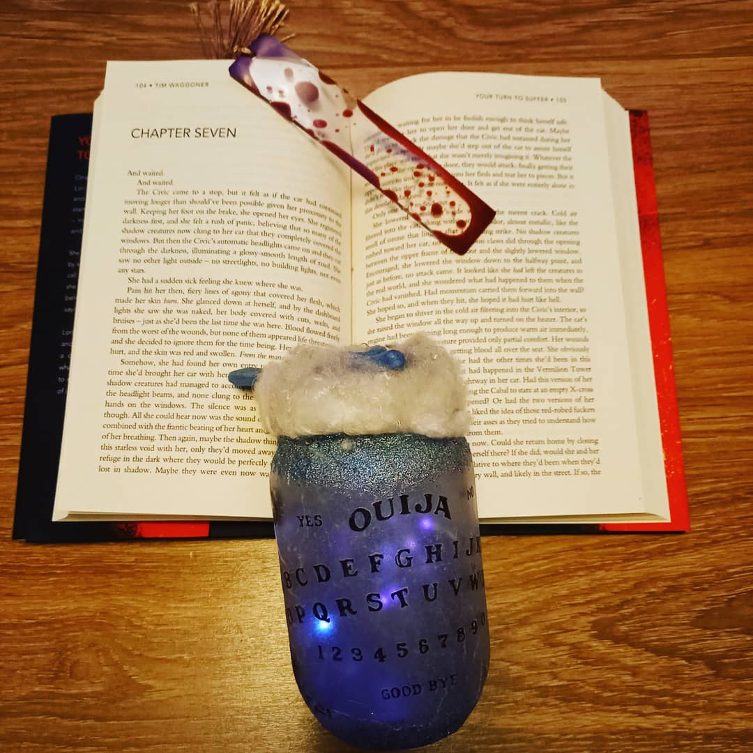 smbslt's tweet photo. Ooh its getting #creepy #supernatural #horrorreads #horrorbookstagram #horrorbook so appropriate #bookmark and my #jarlights #ouija #horrorfanatic #currentread #YourTurnToSuffer #author #TimWaggoner #newreleases out this month xxx https://t.co/zkoqf4ICZc