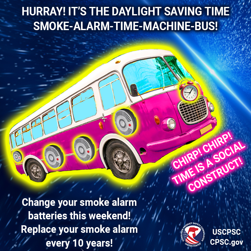 A purple bus covered in smoke alarms and clocks flying through the space-time continuum. The text reads: Hurray! It's the daylight saving time smoke-alarm-time-machine-bus! Chirp! Chirp! Time is a social construct! Change your smoke alarm batteries this weekend! Replace your smoke alarm every 10 years!