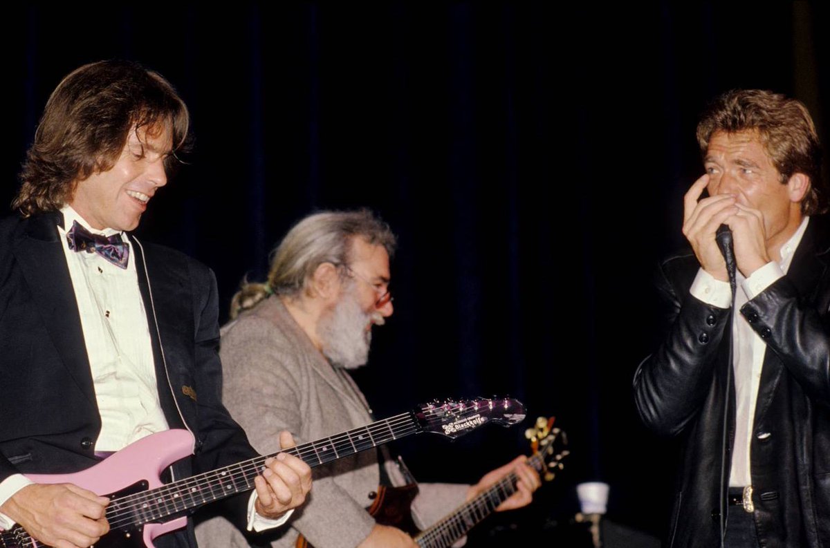 GratefulDead's tweet photo. The Grateful Dead, in suits?

It happened on this day in 1988 at the Bay Area Music Awards. Pictured here is Huey Lewis, @BobWeir and @JerryGarcia jamming on stage by @JayBlakesberg. https://t.co/tSkcGkJ9QM