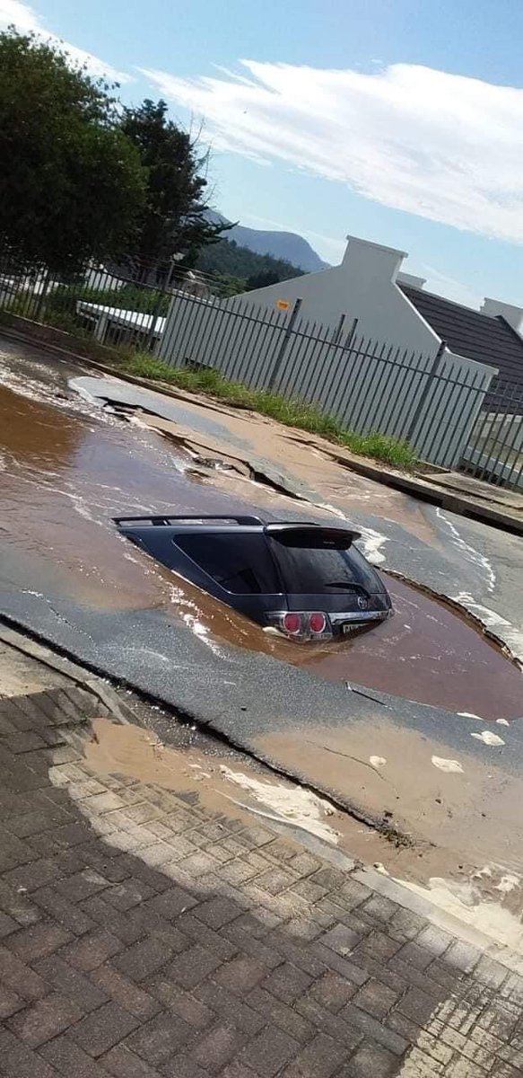 ZwangaMukhuthu's tweet photo. SABC is reporting that a vehicle has fallen into a sinkhole apparently after a pipe burst in the eastern suburbs of George in the Southern Cape. Eye witnesses said the lone driver managed to swim out to safety. https://t.co/ifk5KNnNzz