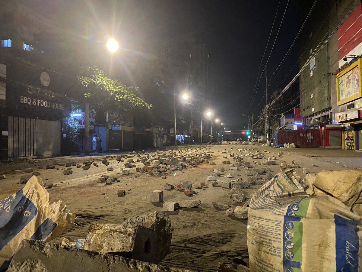 #Myanmar citizens set up makeshift memorial in #Yangon to honour 18-year-old Aung Paing Oo who died Friday after it was reported he was shot in the head by #military security forces. Row of flowers, am told, represents the trail of his blood at same site #WhatsHappeningInMyanmar