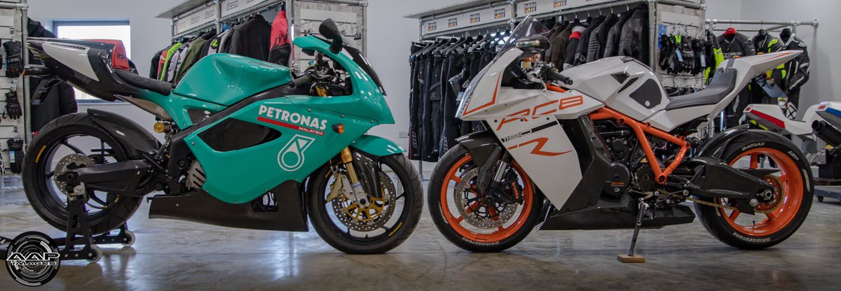 A photo of a historic Petronas FP1 superbike next to a KTM RC8R road bike
