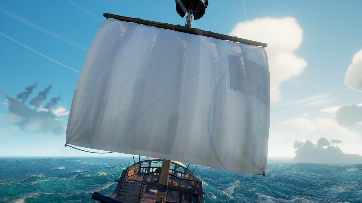 Blank Sloop sails against a perfect blue sky.