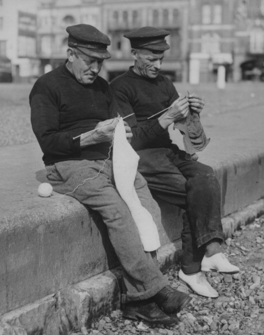 RootsReturn's tweet photo. Two fishermen work on knitting their winter jerseys while waiting for the boats to come in, Ramsgate, England, early to mid 20th century. https://t.co/Jy0OedUK7P