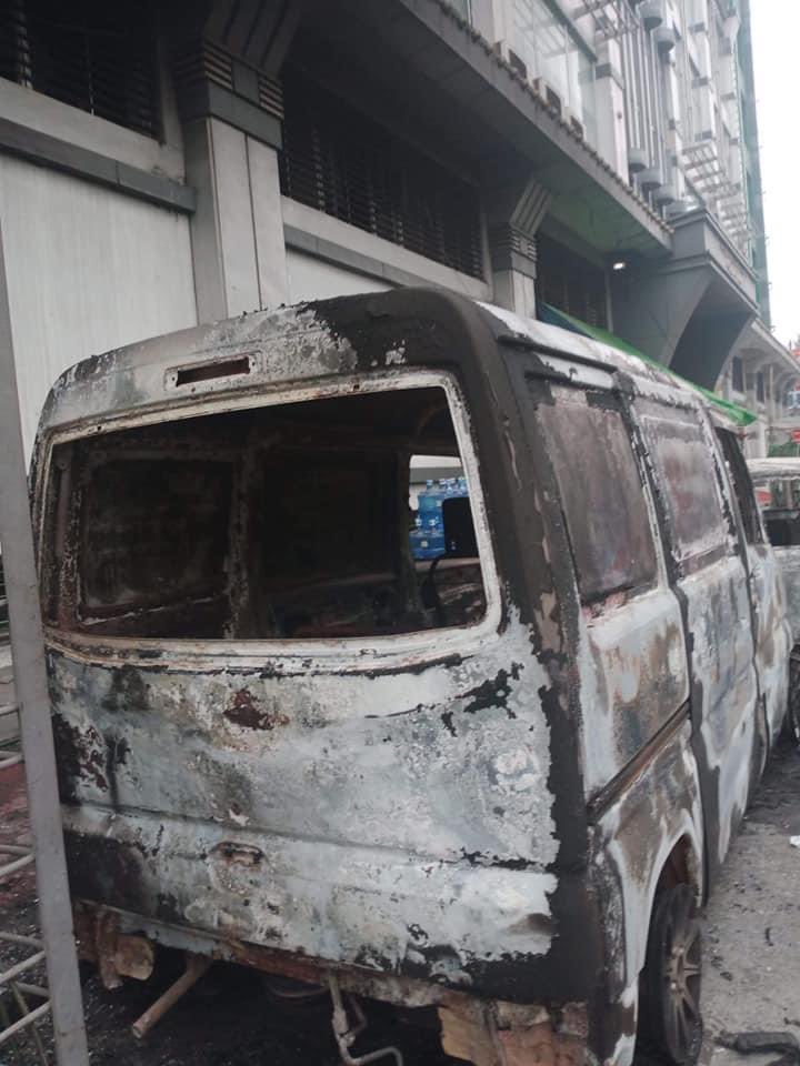 grammephyo's tweet photo. Two burnt cars were spotted this morning in front of AKK shopping mall in #Thingangyun. Terrorists burning civilian's properties. These are the scenes we’d see in movies but this is a reality happening right now in #Myanmar. #WhatsHappeningInMyanmar #Mar15Coup https://t.co/oSULMNx3fL