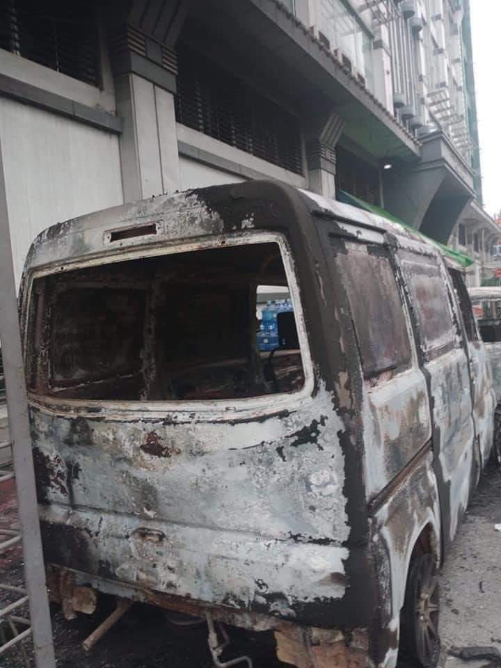 Veronic64454936's tweet photo. Two burnt cars were spotted this morning in front of AKK shopping mall in Thingangyun. Terrorists burning civilians' properties. This a reality happening right now in Myanmar.
#WhatsHappeningInMyanmar #Mar15Coup  
BLOODTHIRSTY JUNTA https://t.co/yt4JVrVDby