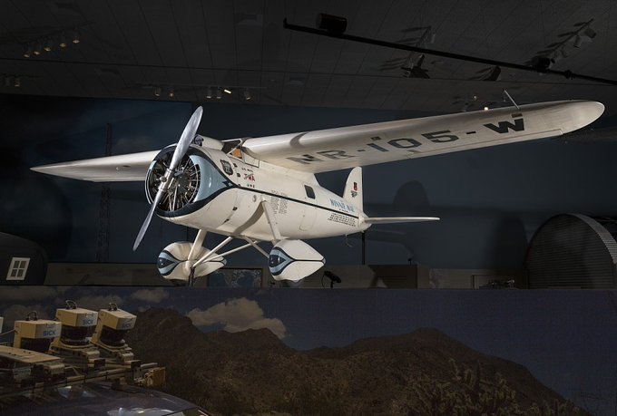 White Lockheed Vega hanging in museum setting.