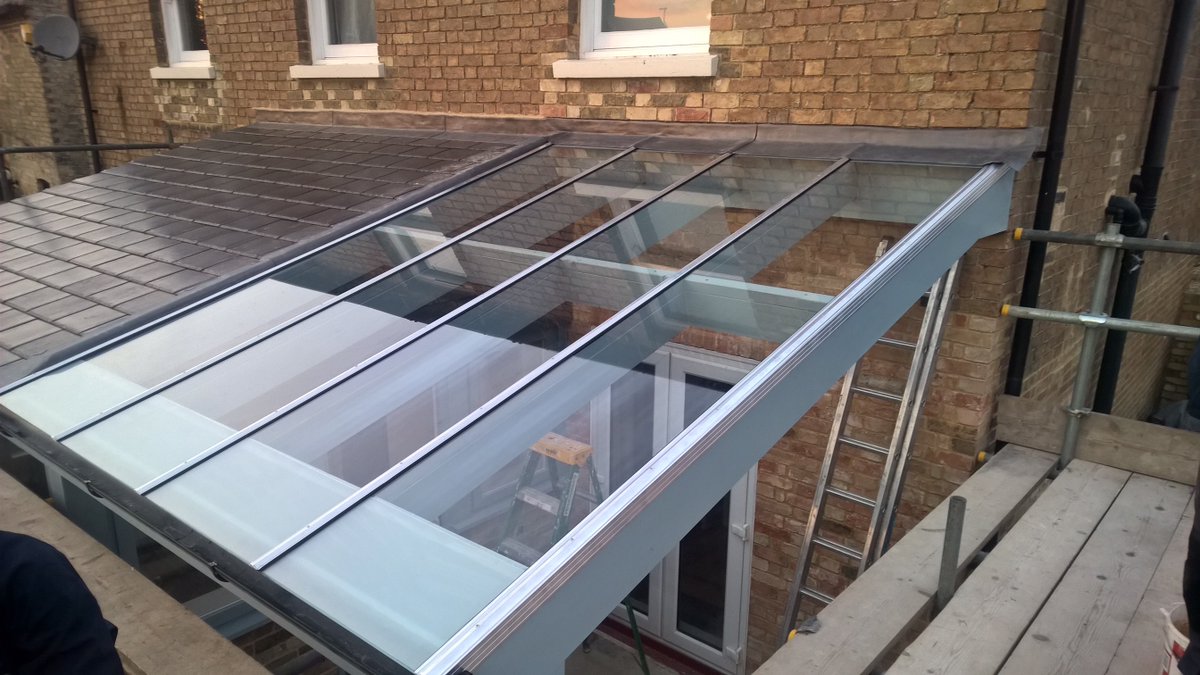 Glass roof canopy being installed to this property, creating a fantastic shelter in the warmer weather to enjoy outside living come rain or shine.