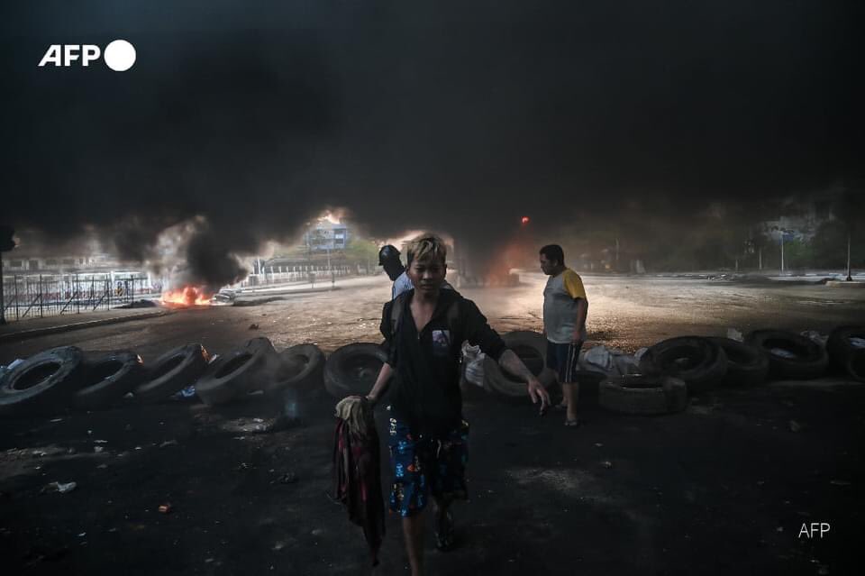 Plumes of smoke are rising above a part of Yangon that has turned into a battle zone, with burning barricades and security forces firing at unarmed anti-coup protesters. #AFP #SaveMyanmar