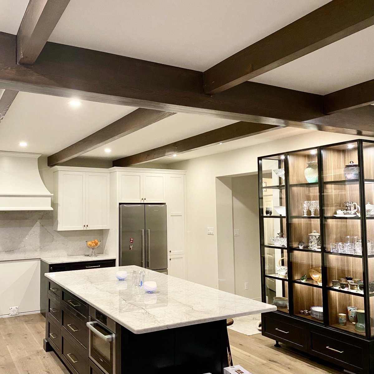 Behind the scenes! We’re wrapping up this kitchen and putting the final touches in. We love the custom cabinetry with the glass display 😍 
#ygk #interiordesign