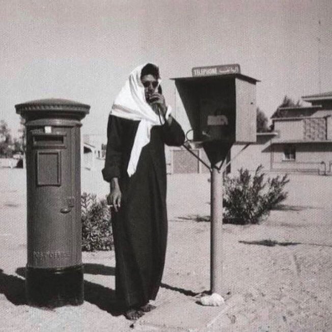 A picture that was taken in 1964 of a man using a public phone in Kuwait in Al Ahmadi area.