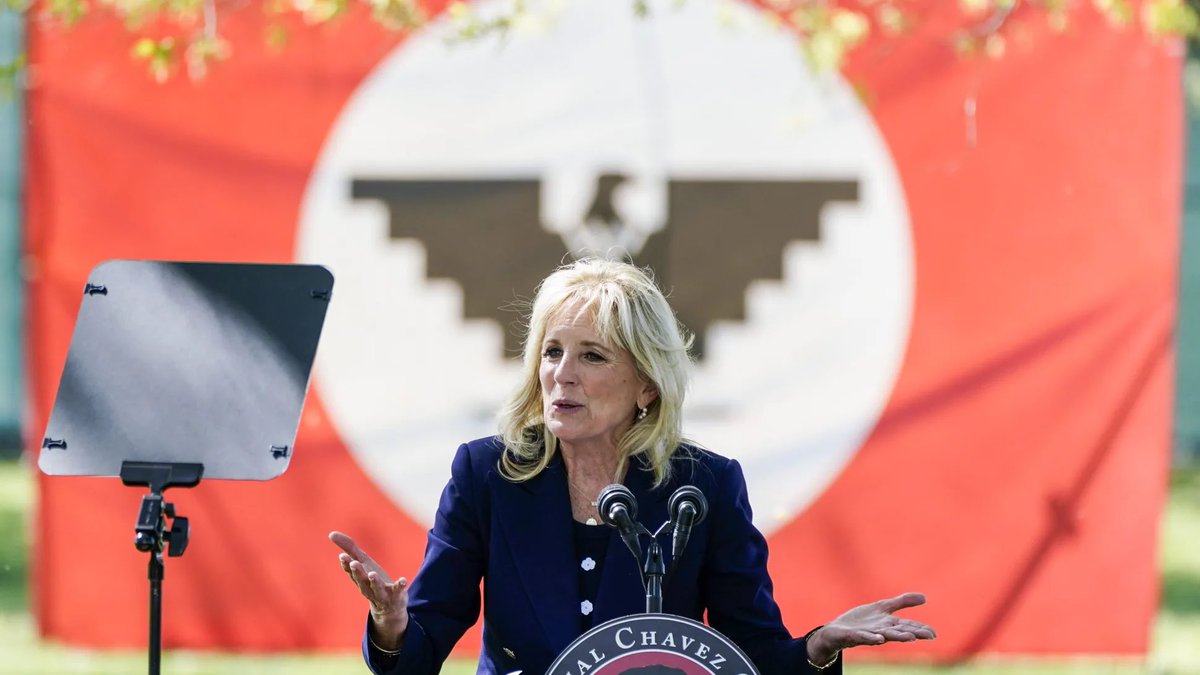 JackPosobiec's tweet photo. Jill Biden spoke in front of a Nazi-inspired flag yesterday https://t.co/cJEyuZFxJp