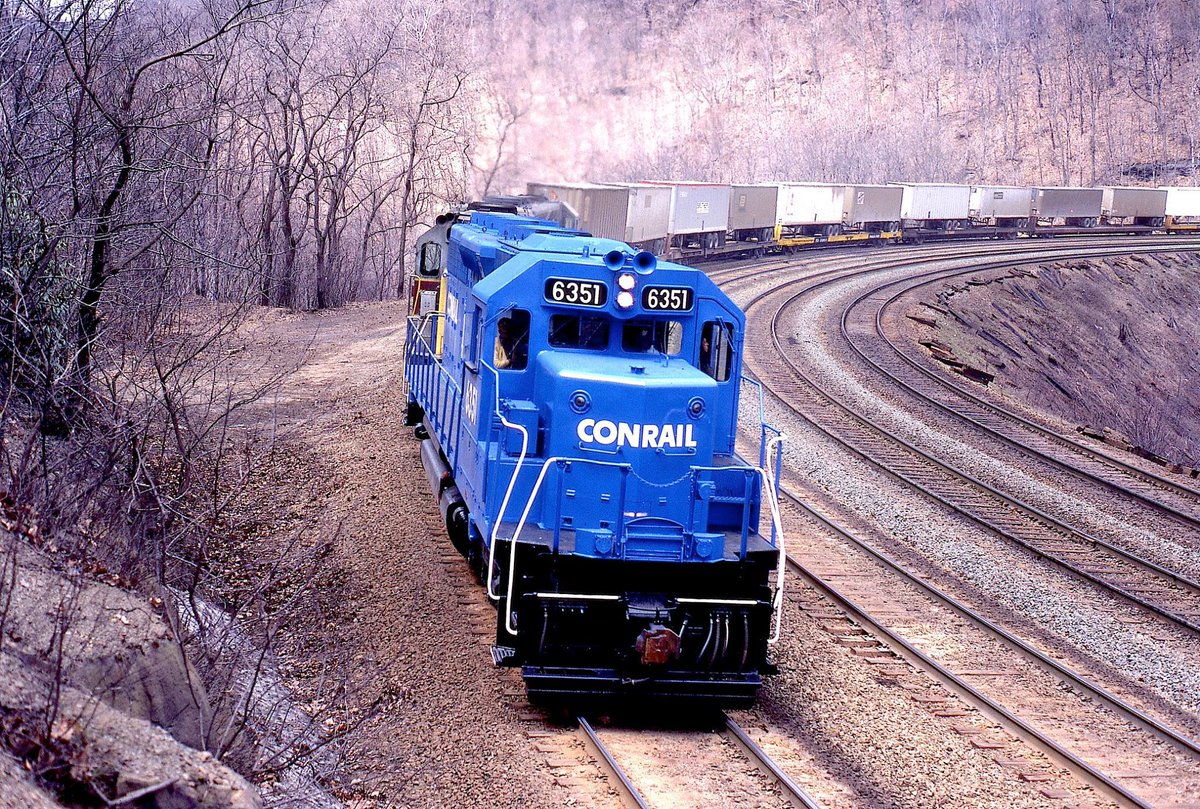 A brief history of Conrail, which launched operations on this date 45 years ago to untangle the collapsing rail service in the Northeast.  Here, recently repainted SD40 #6351 grinds upgrade with westbound 'vans' on Horseshoe Curve. Warren Calloway photo.  american-rails.com/conrail.html