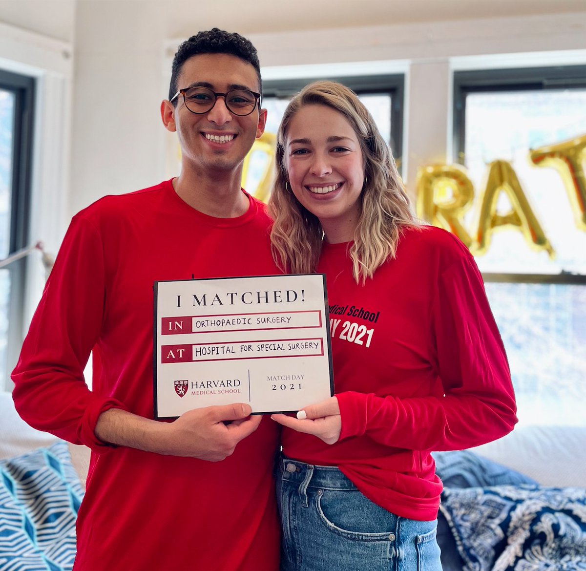 Two students hold a sign that reads, "I matched!"