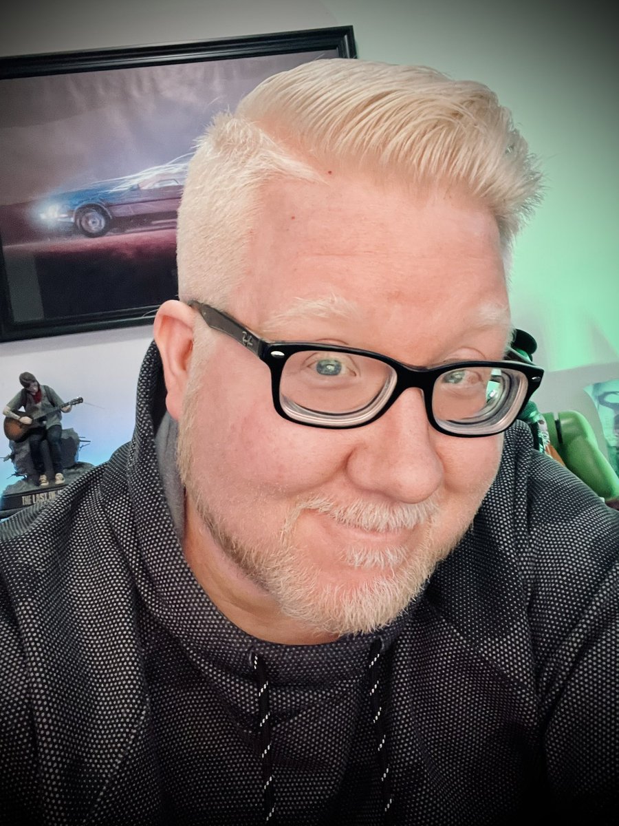 Selfie of my new haircut with my sides buzzed down. The top has some length to it but the sides and back are all buzzed down.