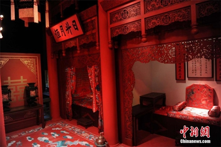 NUPTIAL CHAMBERAfter the ceremony, the couple enters the 洞房 dòng fáng. No time wasted! This is where the groom will finally unveil his bride! Everything is in red.[Replica of Emperor Kangxi's nuptial chamber at the Palace of Earthly Tranquility within the Forbidden City]