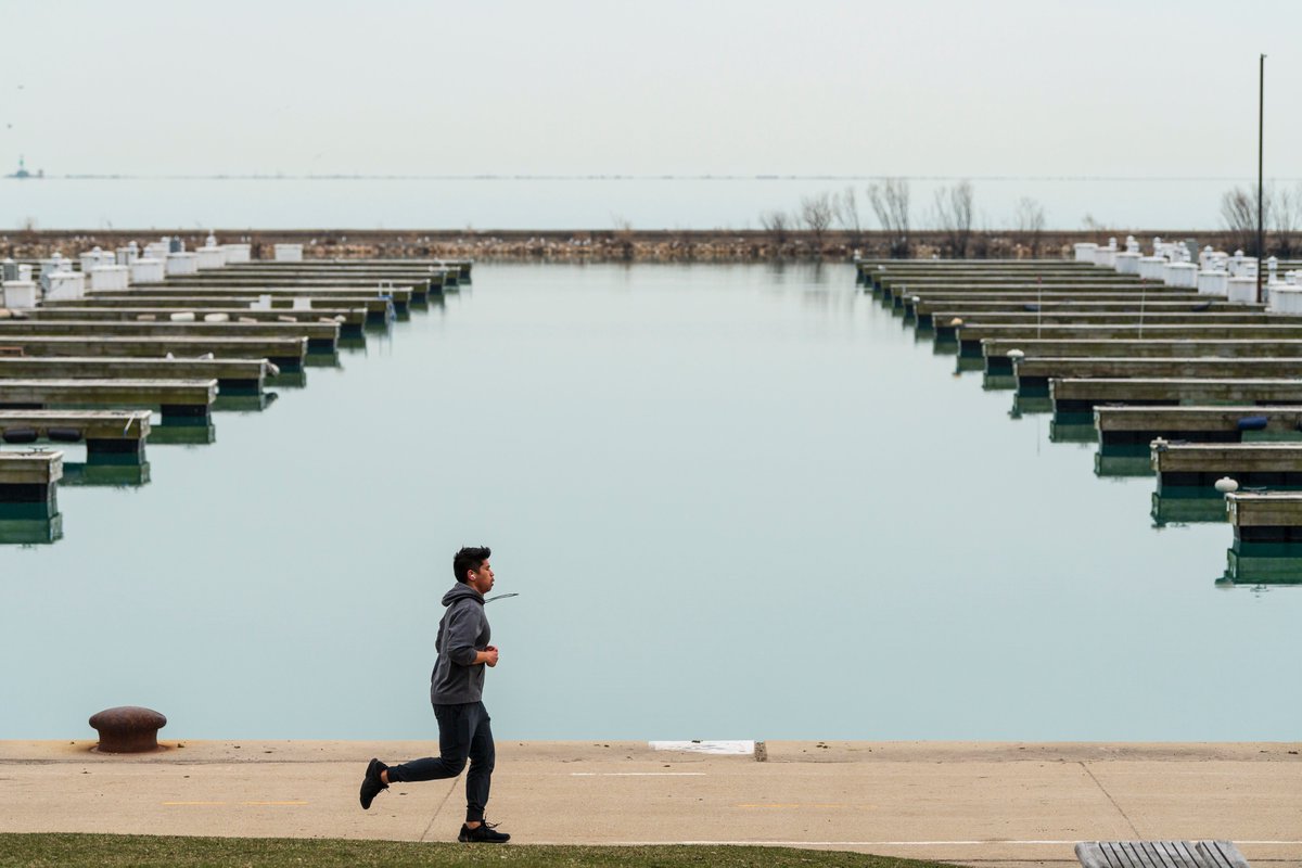 This is a photo of a runner taking a jog on the closed lakefront.