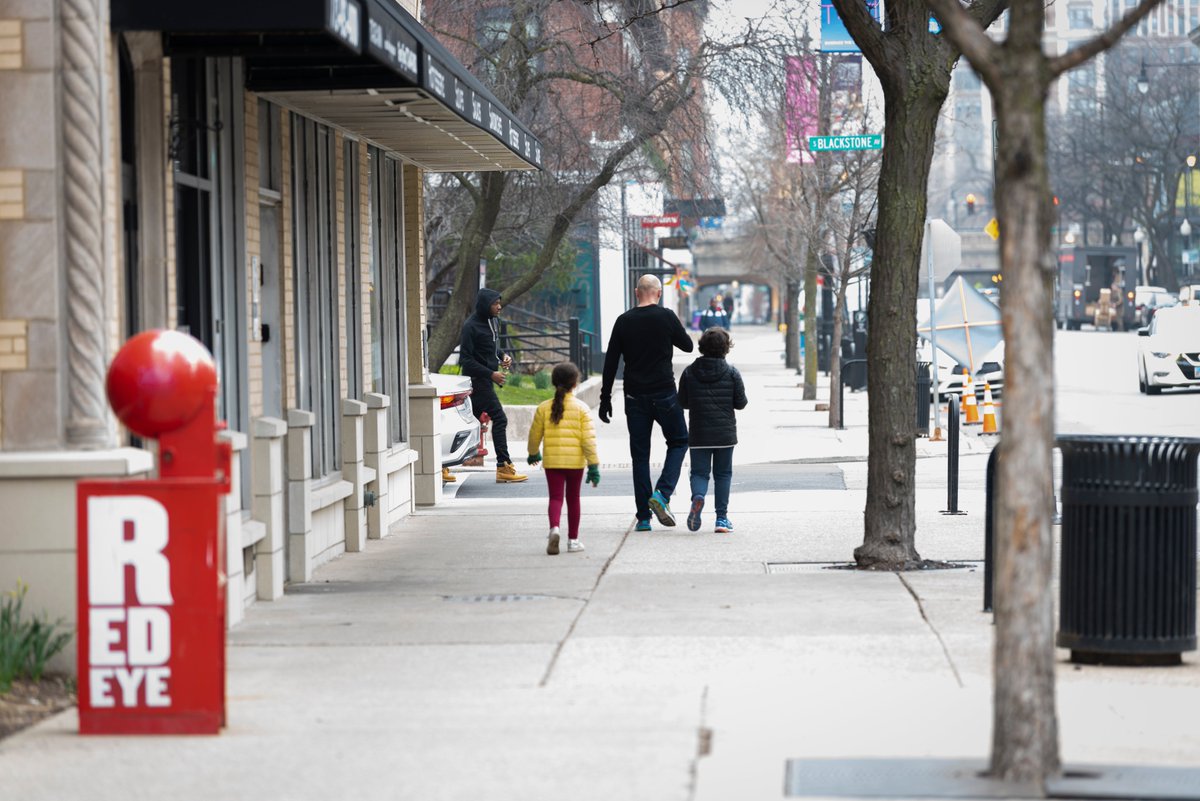 This is a photo of a family walking down the street in Hyde Park.