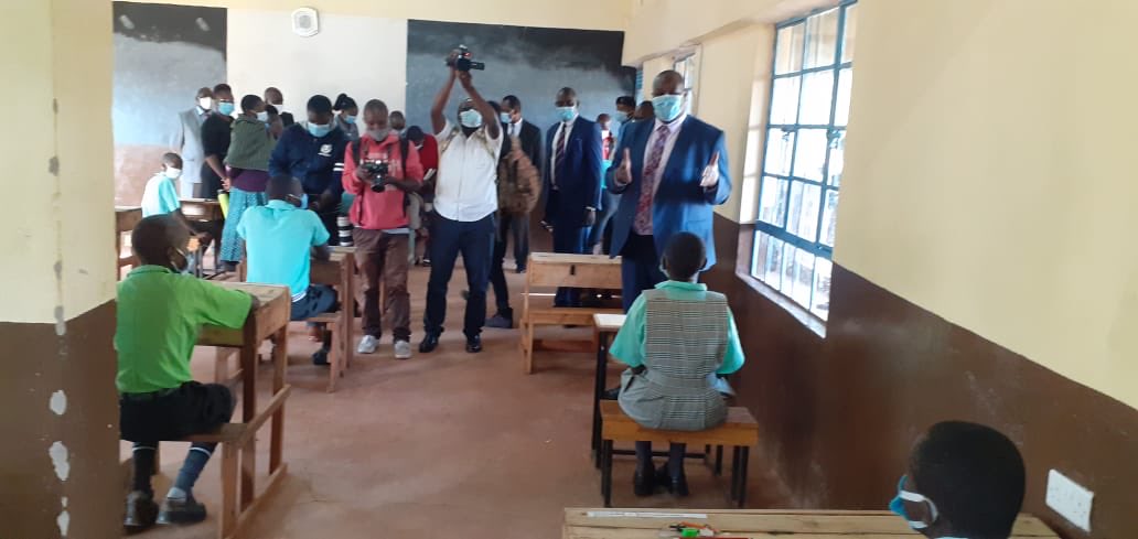 Basic Education PS Julius Jwan (Standing, right) monitors the start of the Math exam paper at Kisii Central  Primary school on Day One of the 2020 KCPE exams.