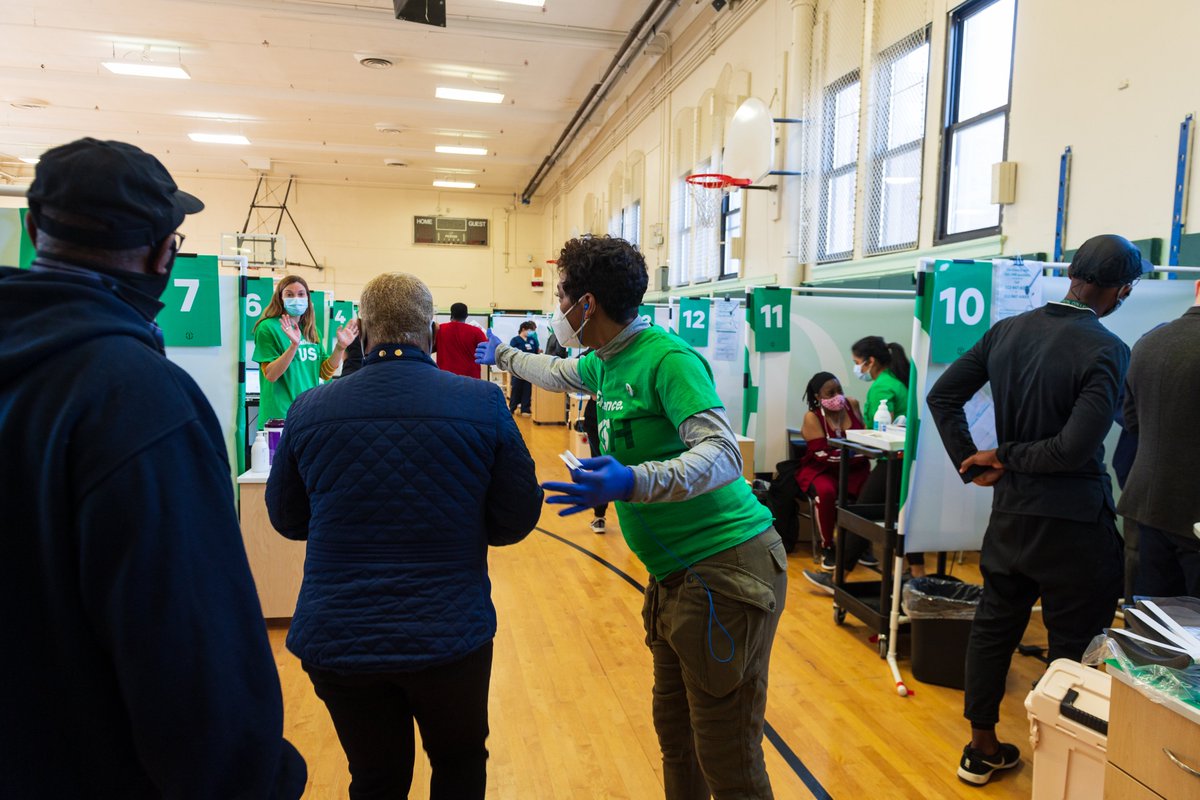 This is a photo of a Rush Medical volunteer a directing a resident of Austin to receive their vaccination.