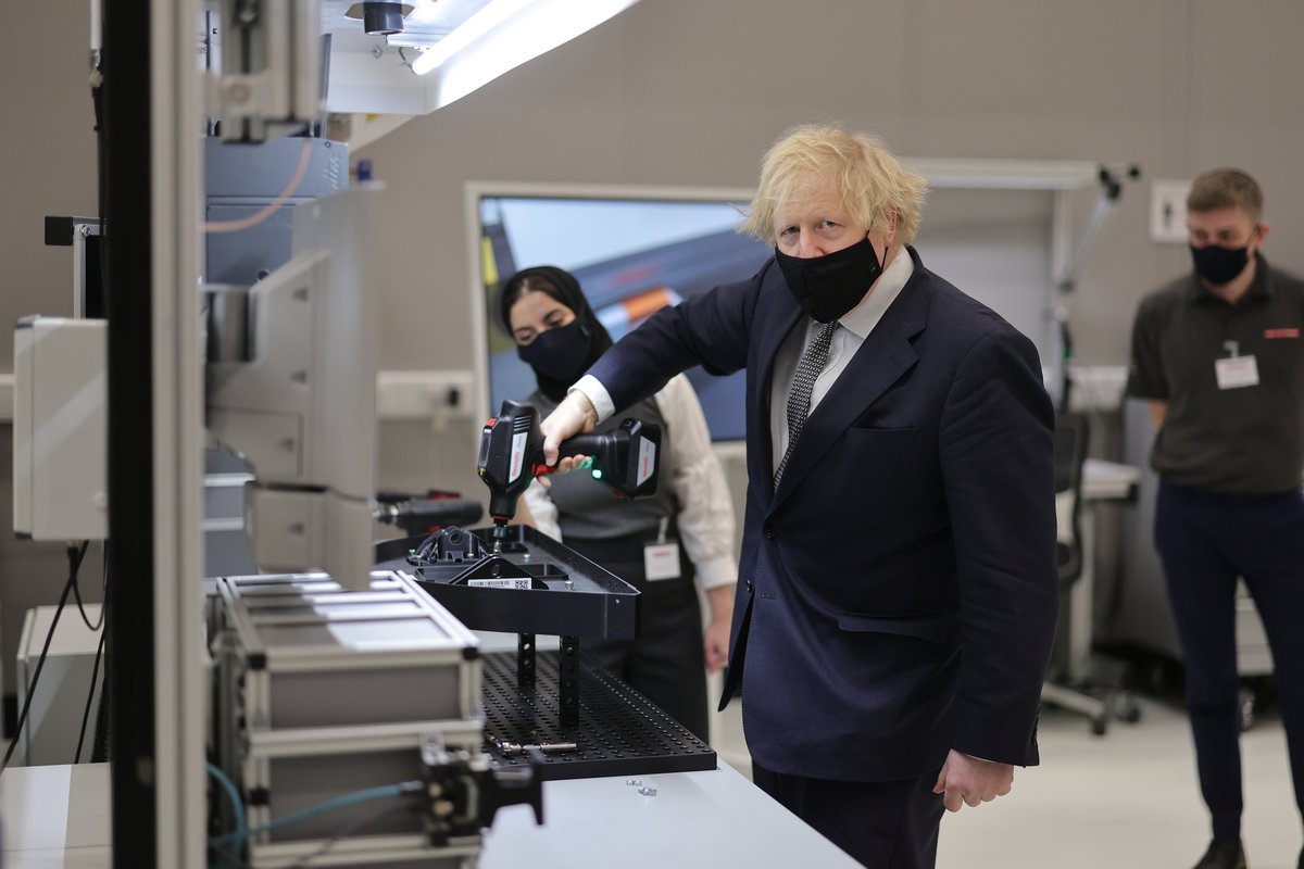 Prime Minister using a drill 