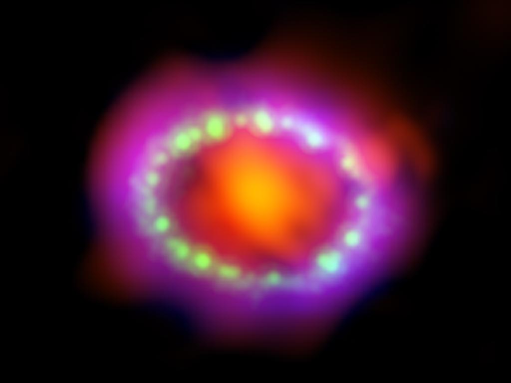 Astronomers combined observations from three different observatories (Atacama Large Millimeter/submillimeter Array, red; Hubble, green; Chandra X-ray Observatory, blue) to produce this colorful, multiwavelength image of the intricate remains of Supernova 1987A.
Credits: NASA, ESA, and A. Angelich (NRAO/AUI/NSF)