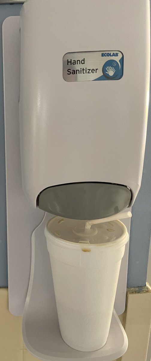 Hand Sanitizer Dispenser put to use by someone. “Hold my drink, will ya!”