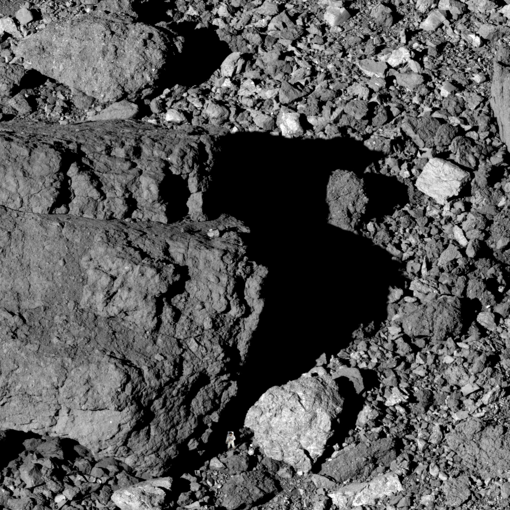 JPMajor's tweet photo. Boulders of all sizes on the surface of the asteroid Bennu, imaged by @OSIRISREx two years ago on March 22, 2019. I inserted a Buzz Aldrin for comparative scale size. https://t.co/NOm0C5TLzE