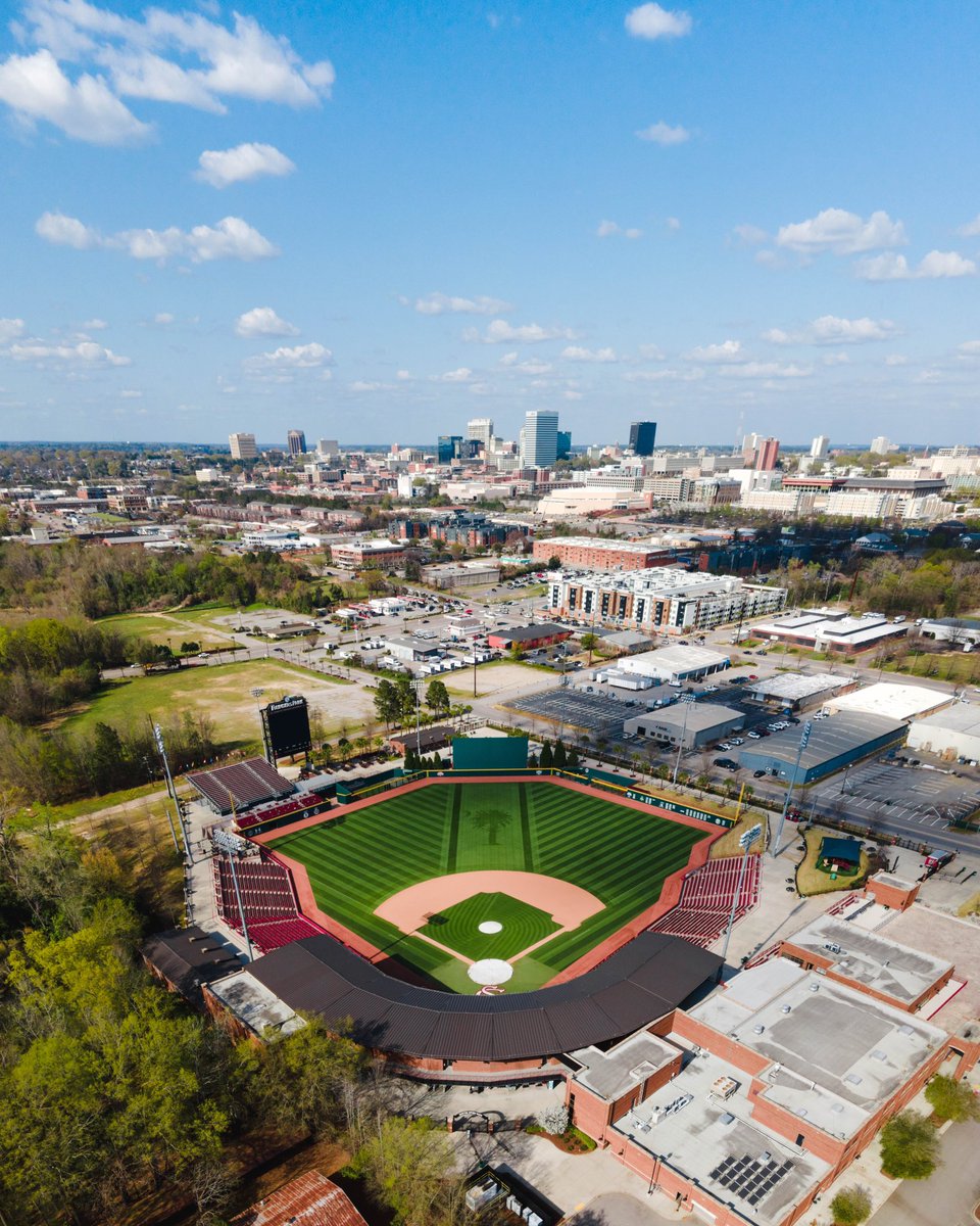An arial photo of Founders Park baseball field in the foreground and the Columbia skyline in the background.