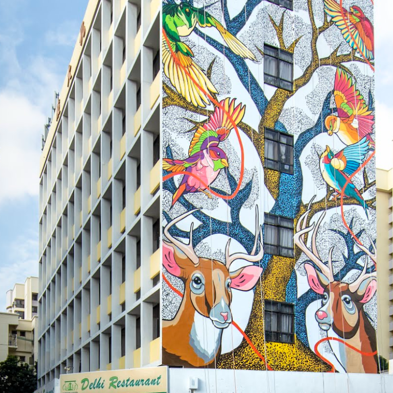 Google's tweet photo. Artists Bhajju Shyam and Sam Lo overcame a distance of thousands of miles to jointly create street art. Follow the creation of their new mural in SG's Little India by @StreetArtIndia with @VisitSingapore on @googlearts #SingapoReimagine #PassionMadePossible #ARTWALKLittleIndia