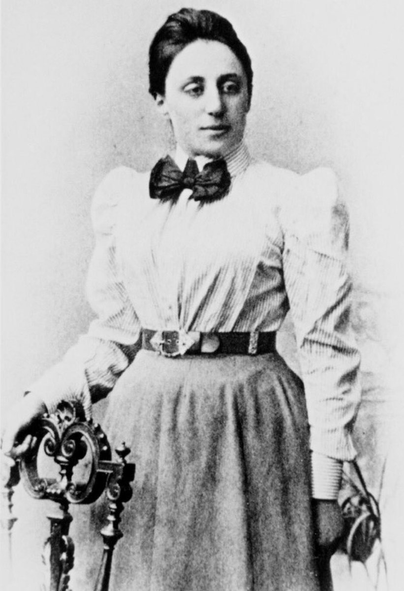 Black and white portrait of Emmy Noether standing. She is in her early-to-mid twenties.