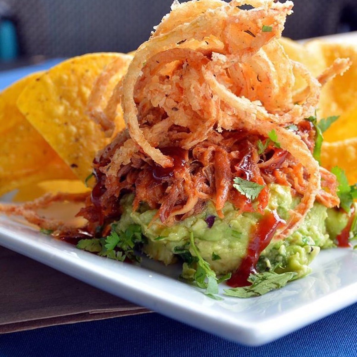 RumbaRumBar's tweet photo. Chip, chip, hooray — it's #NationalChipAndDipDay! The BEST way to celebrate?! #PulledPork #Guacamole with smothered pulled rib, crispy onions, and fresh #tortillachips. One of our first course options on our #lunch #prixfixe menu every weekday here or to go! #rumbahamptonbays https://t.co/LFdL4UbqCt
