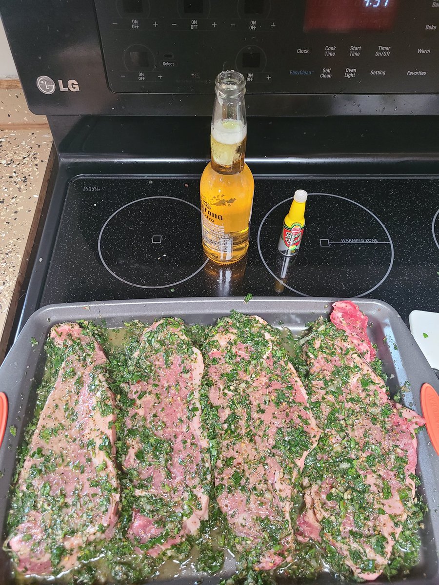 CODYUNDERWOOD90's tweet photo. What's this? A #CookingWithRedneck post!? It's been a while, but i got my son here and tomorrow off. #Coronawithlime, plus a little beer salt, and some New York Strips with #chimichurri. Also some HUGE potatoes the wife is gonna make twice baked. (Picture update when finnished) https://t.co/fs7sidRSJD