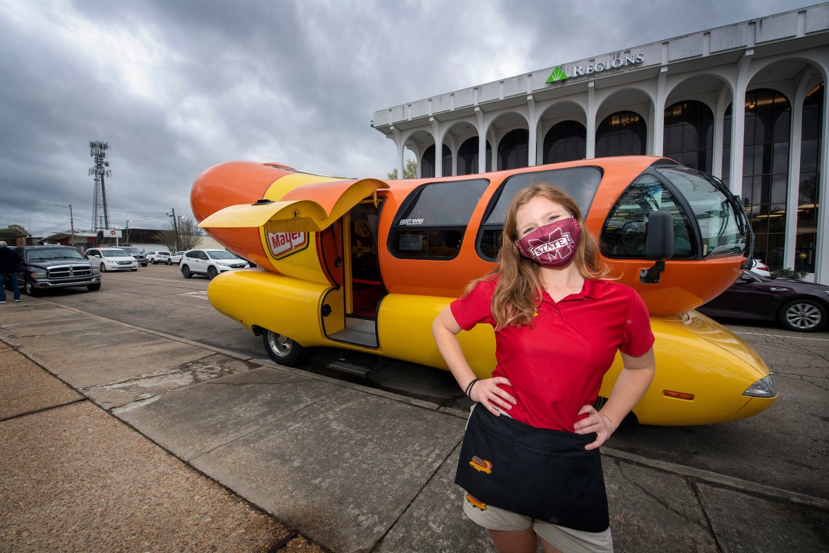 MSU communication alum Maggie Thomas, a brand ambassador for Oscar Mayer, rode into Starkville in the company’s Weinermobile today and cleared the rain! In her job, the Bulldog alum pilots the vehicle across the country. Stop by before 5 pm to grab a hot dog!