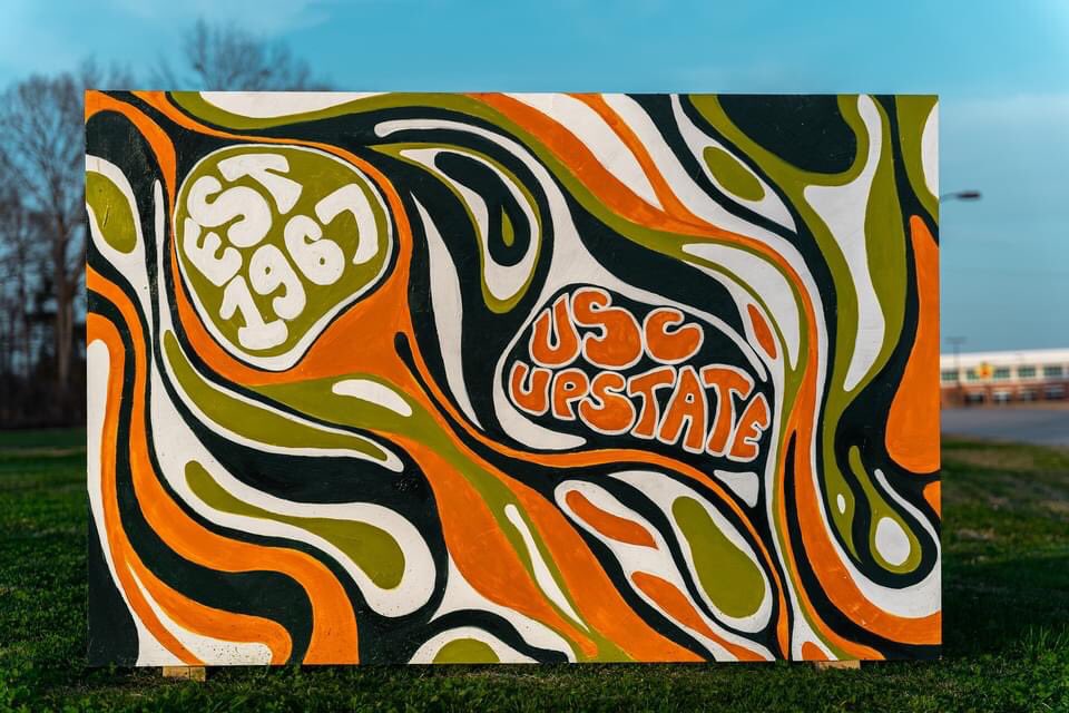 USCUCarolinian's tweet photo. HOMECOMING 2021 week celebrations continue! 
Congratulations to Art instructor Jenny Bonner and her Painting II class for creating these Upstate celebrating billboards. 
Make sure to check these and more out on campus, check 👉🏽 the map! https://t.co/GSCkpQbpK0