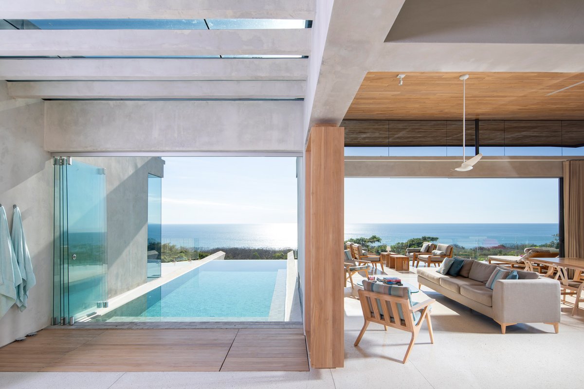 In Costa Rica, Studio Saxe has created a concrete house with expansive coastal views and a swimming pool that reaches toward the sea. dezeen.com/2021/03/23/stu…