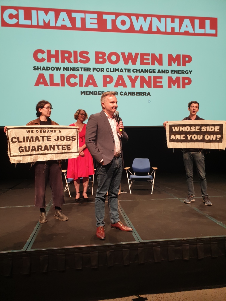 tomorrowmvmt's tweet photo. BREAKING: Young people have taken the stage at a Chris Bowen climate speech at ANU. We are demanding Labor commit to a Climate Jobs Guarantee to solve the climate crisis and end unemployment. https://t.co/YHKIm5nJjt