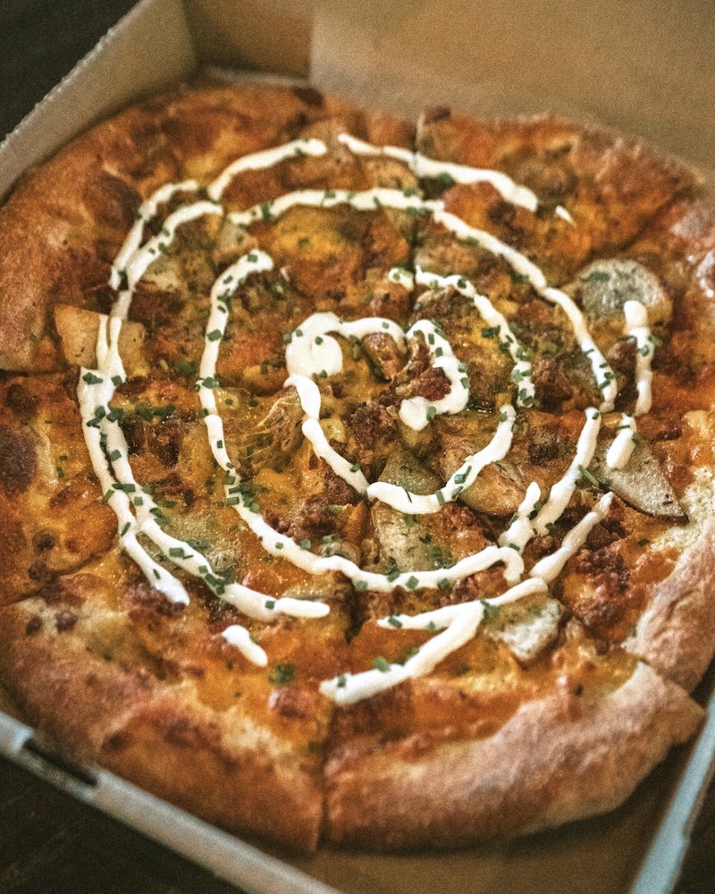 RestoPizzaNM's tweet photo. There's only one more week to get March's pizza of the month. This loaded baked potato pizza is topped with cheddar cheese, oven-roasted potatoes, &amp; crispy bacon, and garnished with fresh chives and house-made crema. This one is tater-tastic, so don't miss out! https://t.co/Y53FJSuk9T