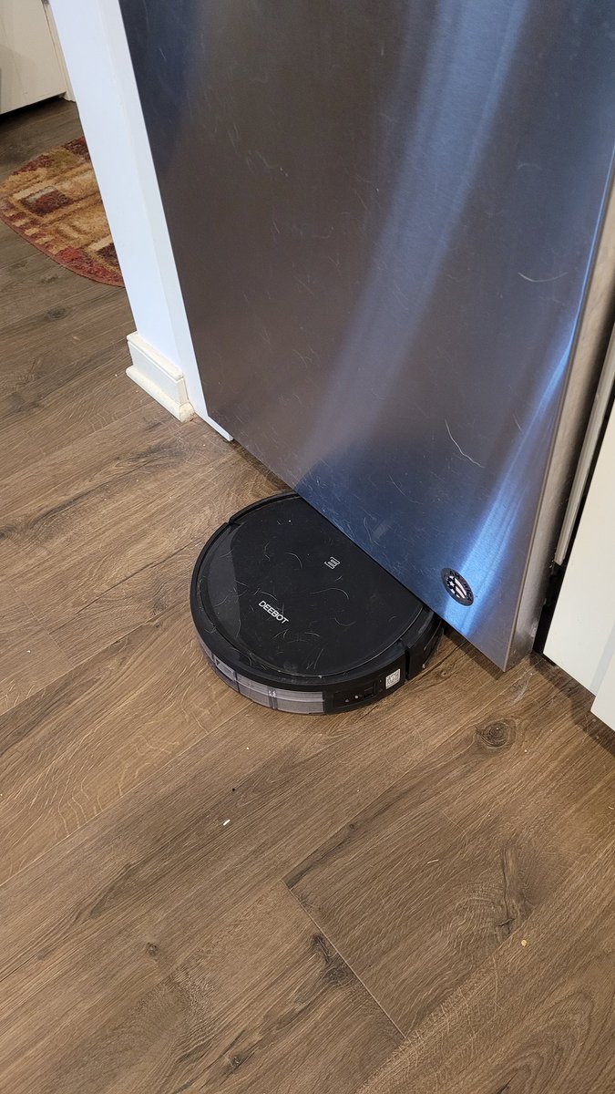 BizzarroRandi's tweet photo. @EcovacsUS @saamato I've been chatting with customer service via email, and they want to send me a refurbished one, which I do not want to accept. I can't leave this thing unattended - see attached picture, just gets stuck somewhere. 🙄☹️ https://t.co/9dsXj41O0a