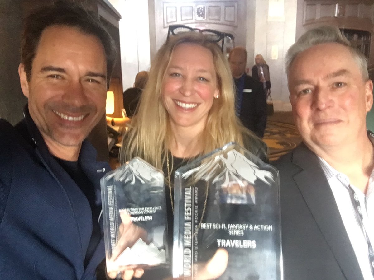EricMcCormack's tweet photo. Hey, #Travelers fans! I’m joining our creator ⁦@bradtravelers⁩ in the a.m. on his new podcast (coming soon!). Here we are with our darlin’ fellow producer ⁦@Carrie_Mudd⁩ in ‘18. If you have any questions or topics for us, POST ‘EM HERE! We’re gonna yack for an hour! https://t.co/2s8uYCXm9b