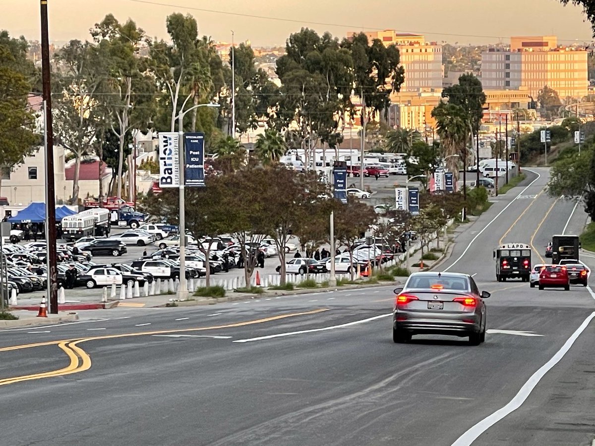 PplsCityCouncil's tweet photo. LAPD staging near Echo Park Lake. Under the direction of the city of Los Angeles and @MitchOFarrell, the cops are going to raid the Echo Park Lake encampment and evict hundreds of residents of the park. 

We can see what the city is doing. ALL EYES ON ECHO PARK TONIGHT https://t.co/YgZKNRhshW